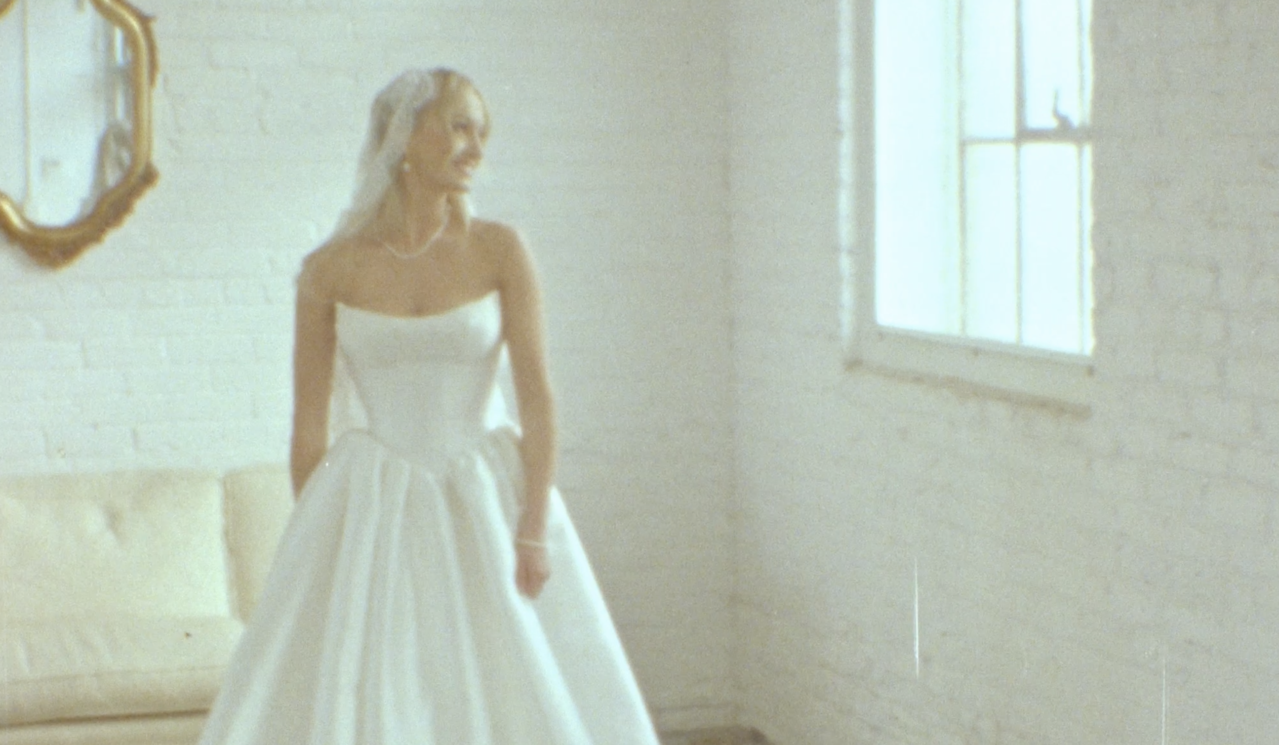 bride looks out window in bridal suite in Northern Pacific Center. The image is on super 8 film.